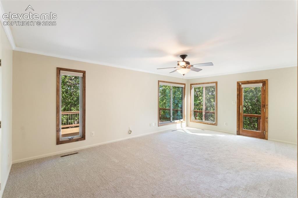 Image 16 of 47: Walkout to wraparound deck, large windows for natural light