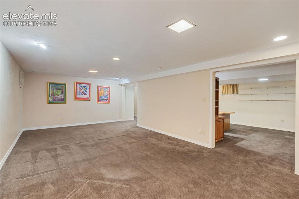 Image 36 of 47: Downstairs Family room open to office