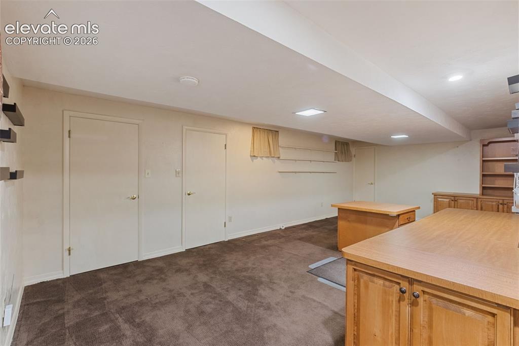 Image 39 of 47: Downstairs office with closets and storage