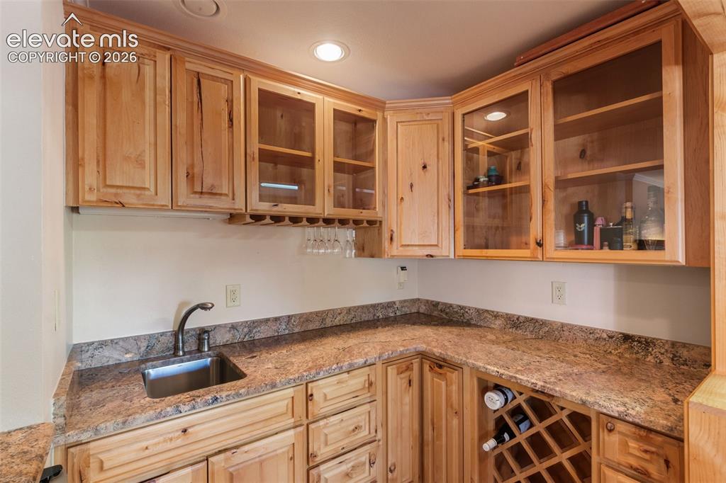 Image 9 of 47: Wet bar between Kitchen and Living Room. Includes wine refrigertor.