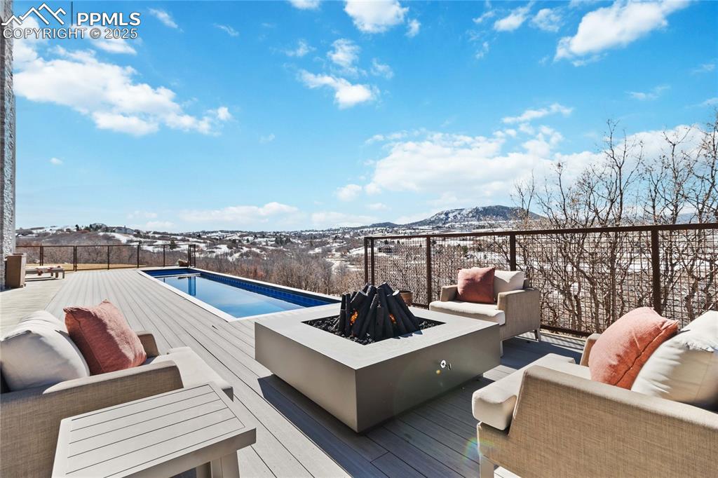 Image 44 of 48: Relax around the pool with a gas fireplace!