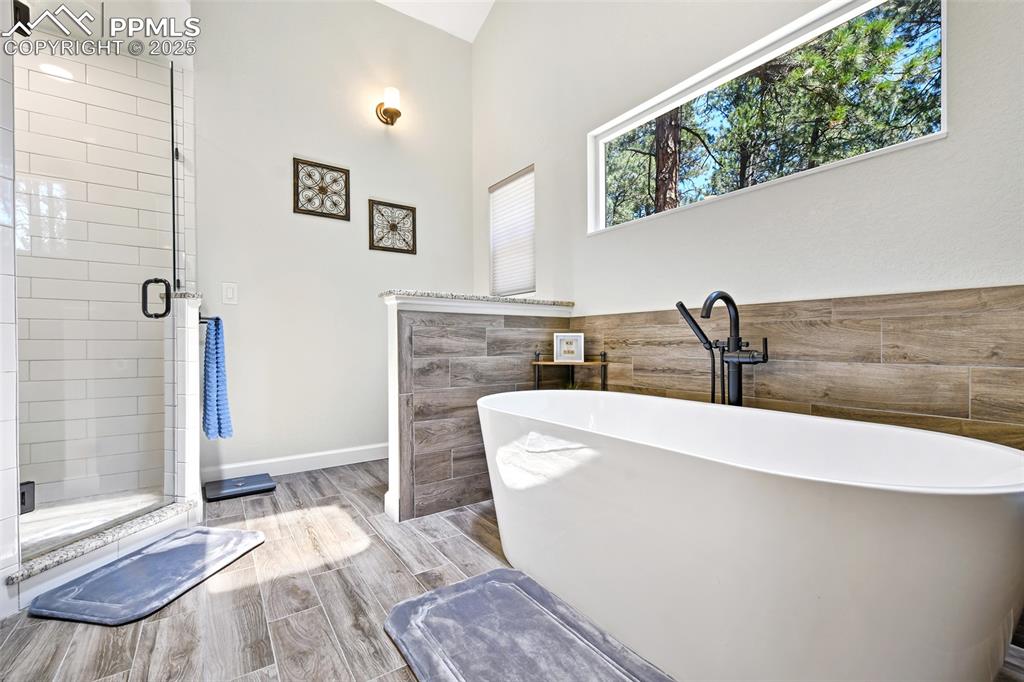 Image 21 of 50: Enormous soaking tub with wonderful transom window
