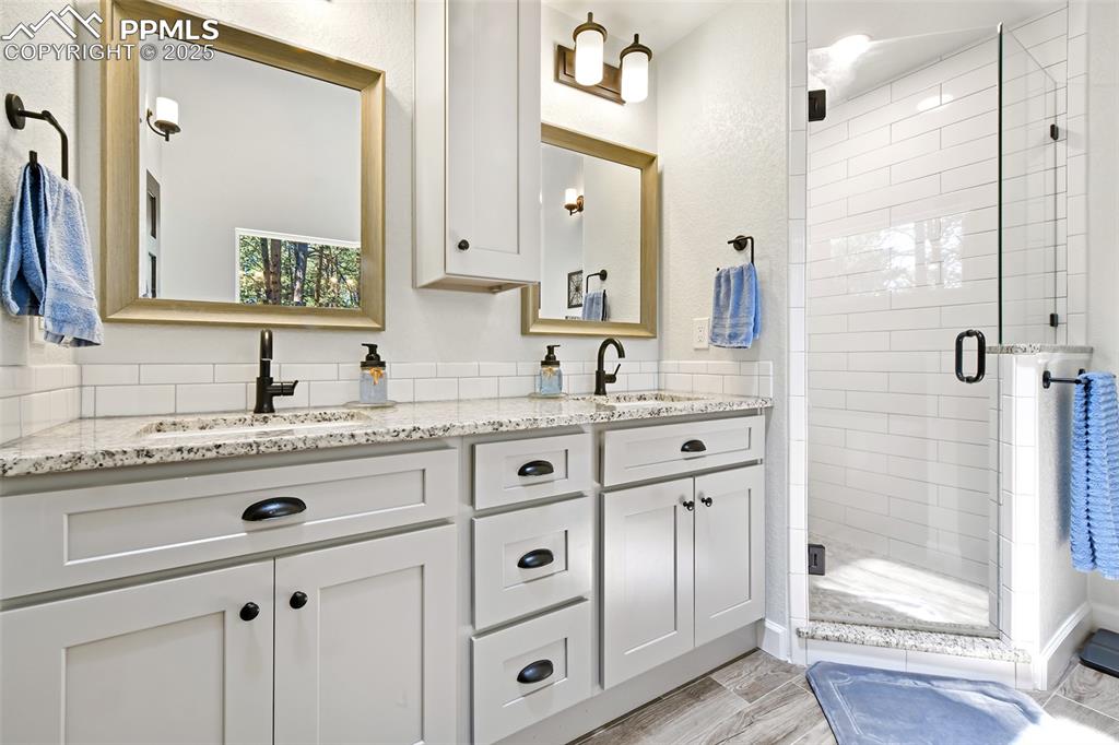 Image 22 of 50: Double vanity and walk-in shower