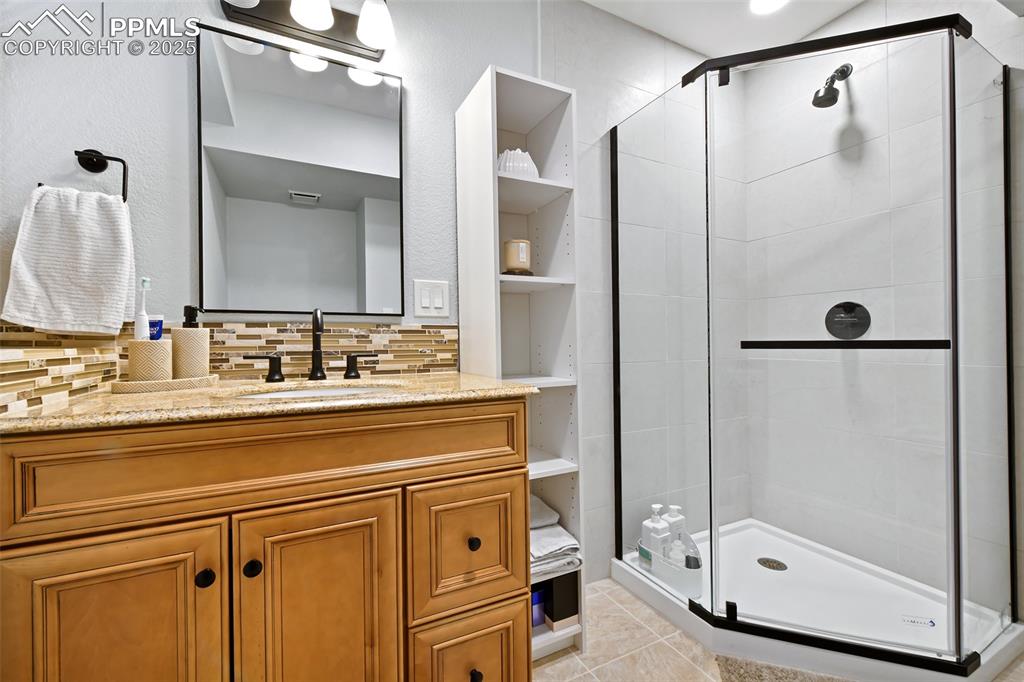 Image 37 of 50: Lower level bath with walk-in shower