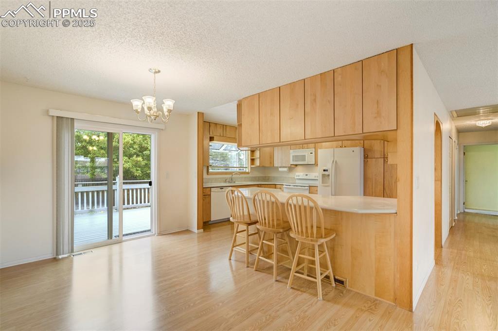 Image 6 of 26: Kitchen walks out to the large back deck and yard