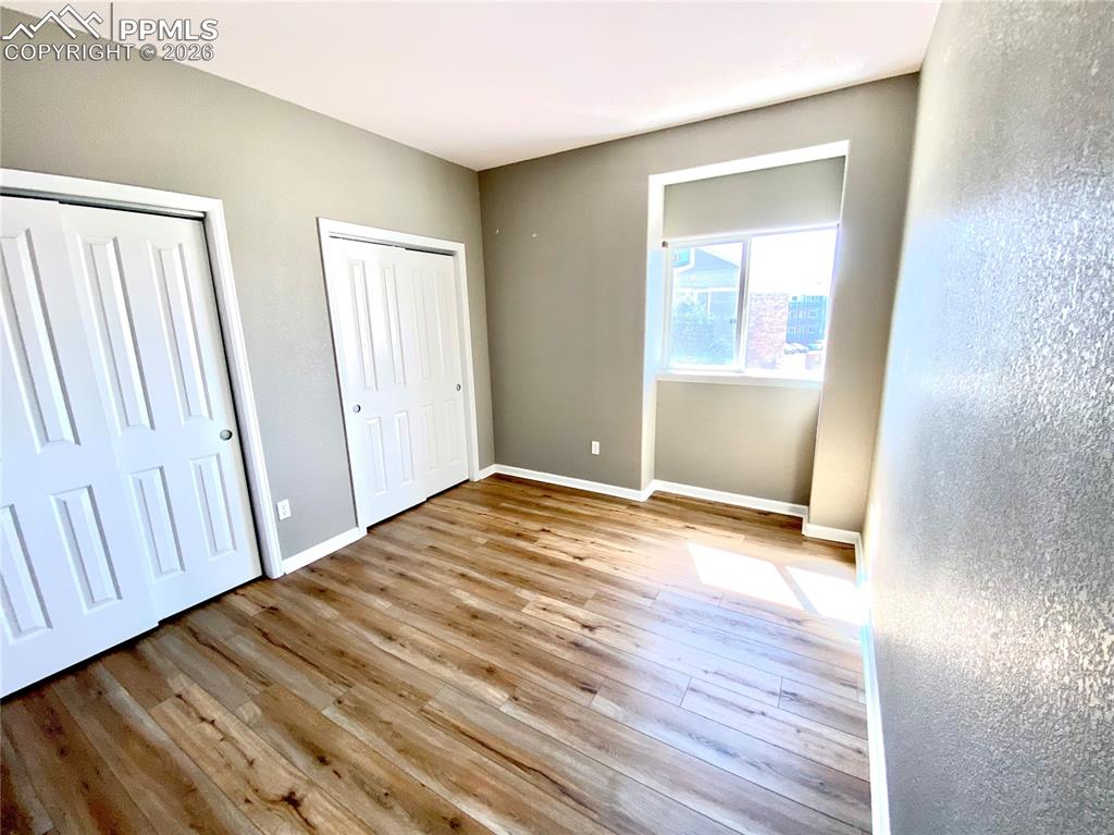 Image 10 of 21: Spacious bedroom with two closet spaces, bay window
