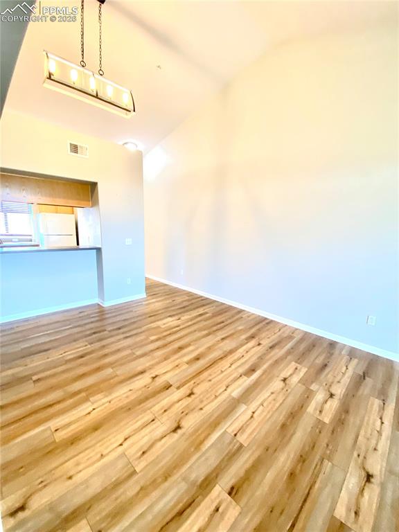 Image 9 of 21: View from the living room toward dining area/breakfast bar/ kitchen