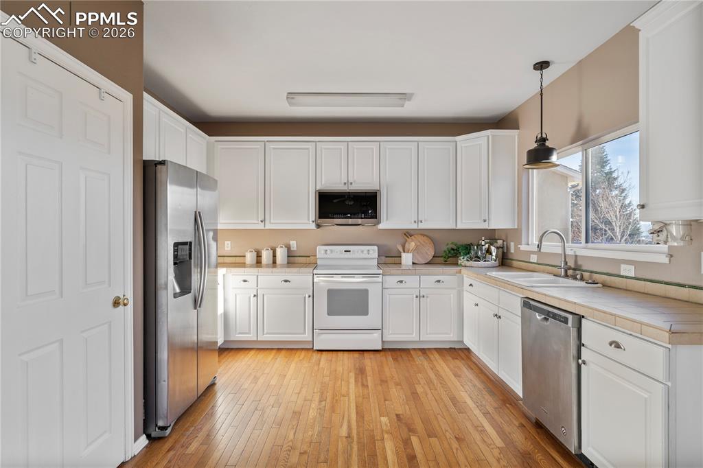 Image 11 of 28: The white cabinetry feels bright and modern.