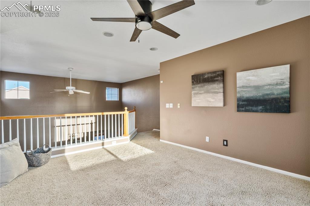 Image 17 of 28: The loft space is a focal point from the entryway.