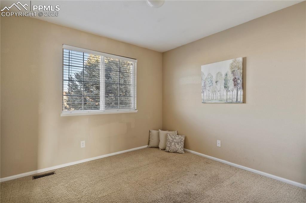 Image 24 of 28: Upper level bedroom, bright and spacious.