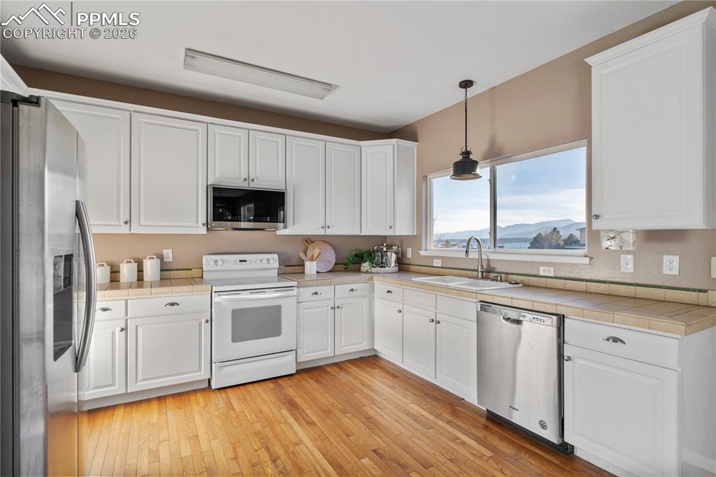 Image 9 of 28: Real hard wood flooring adorns a portion of the main level.