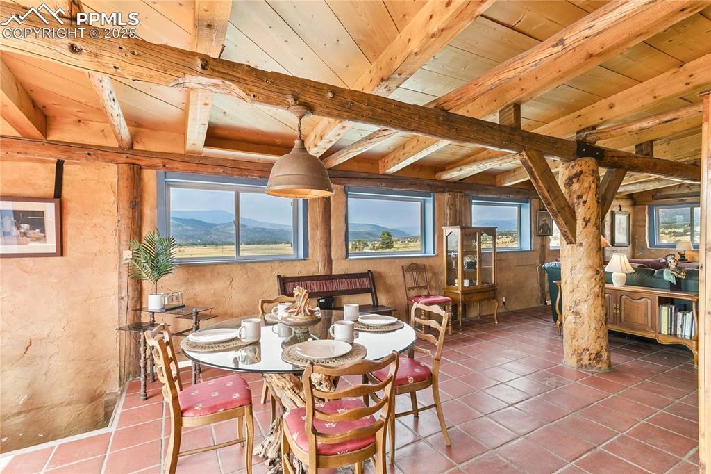 Image 16 of 50: Dining area featuring healthy amount of natural light, a wood ceiling with