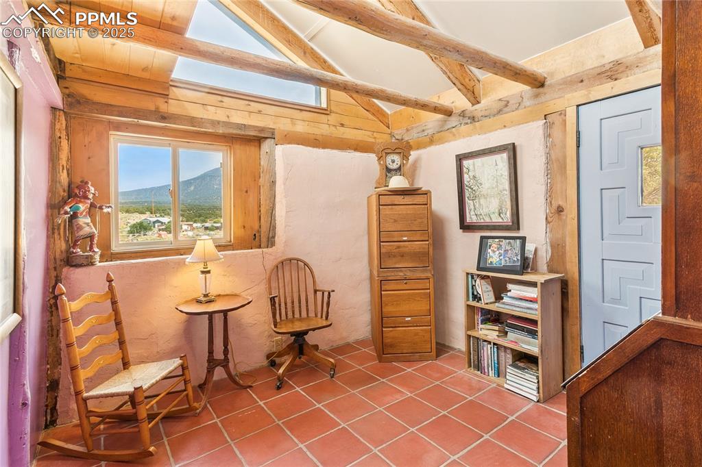 Image 17 of 50: Living area featuring light tile patterned floors