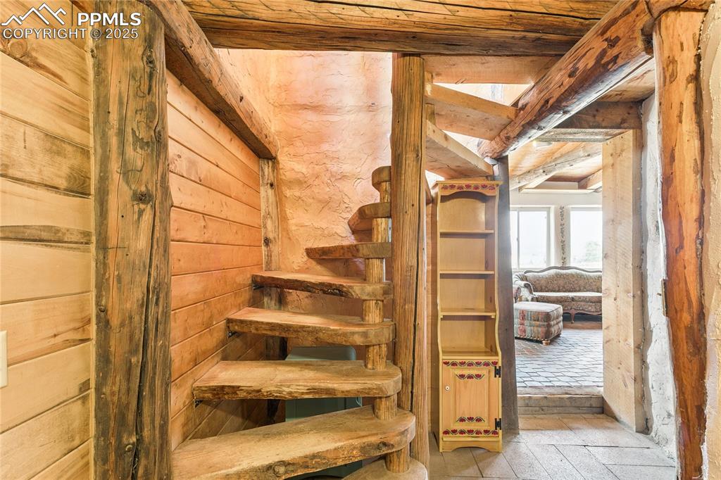 Image 20 of 50: Stairs featuring wood ceiling