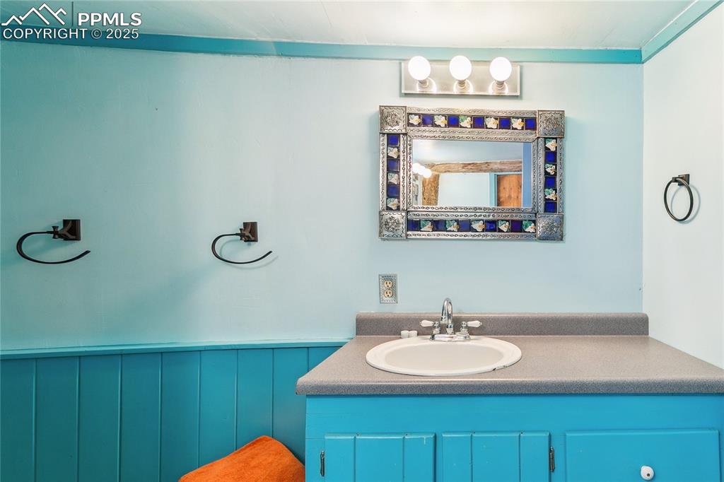 Image 28 of 50: 3/4 Bathroom featuring wainscoting and vanity