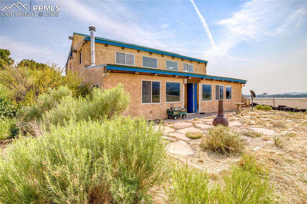 Image 3 of 50: Back of house featuring a patio and stucco siding