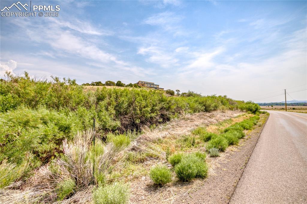 Image 48 of 50: View of asphalt road featuring a view of rural / pastoral area