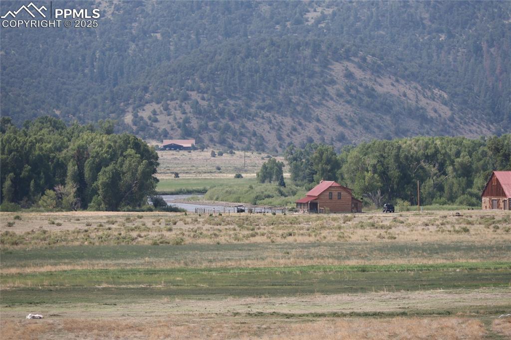 Image 49 of 50: View of mountain backdrop with rural landscape and river view.