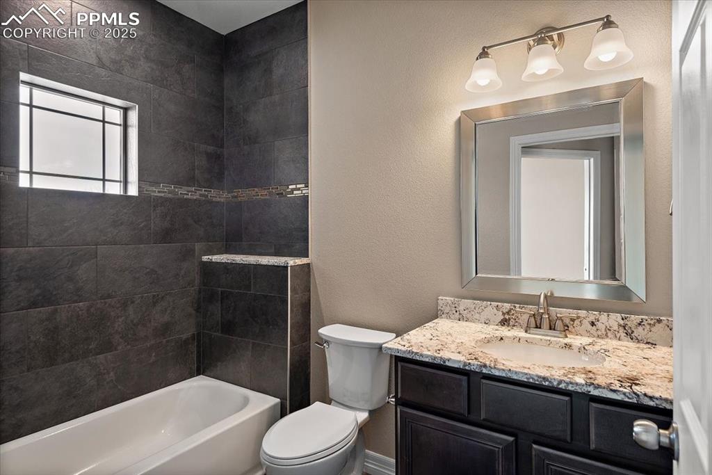 Image 23 of 45: Bathroom with shower / washtub combination, vanity, and toilet