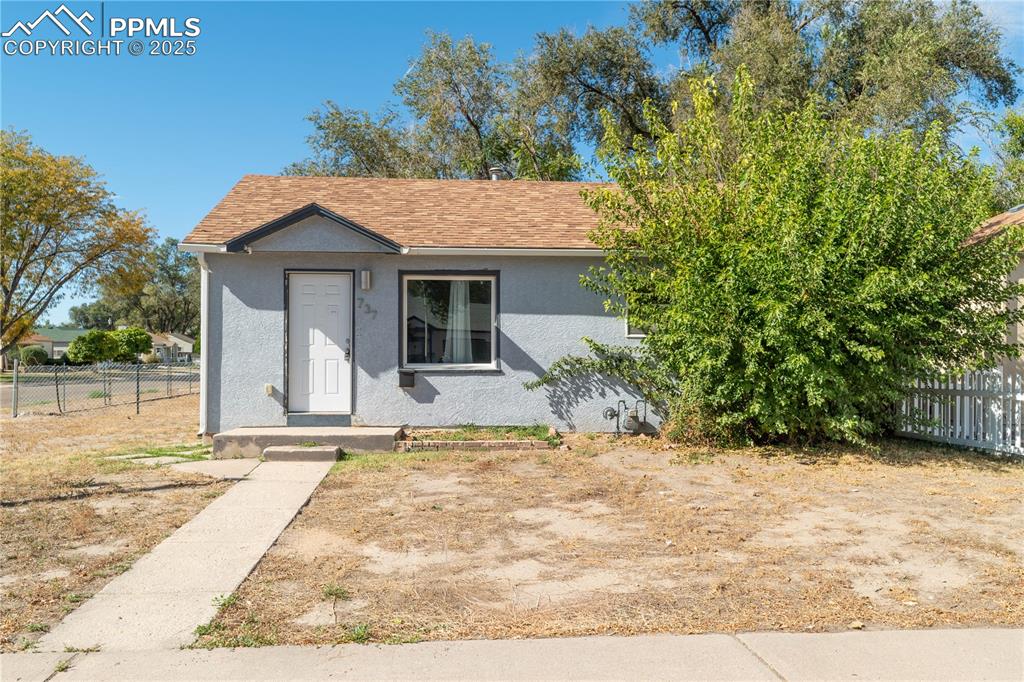 Image 2 of 11: View of front facade with stucco siding and roof with shingles