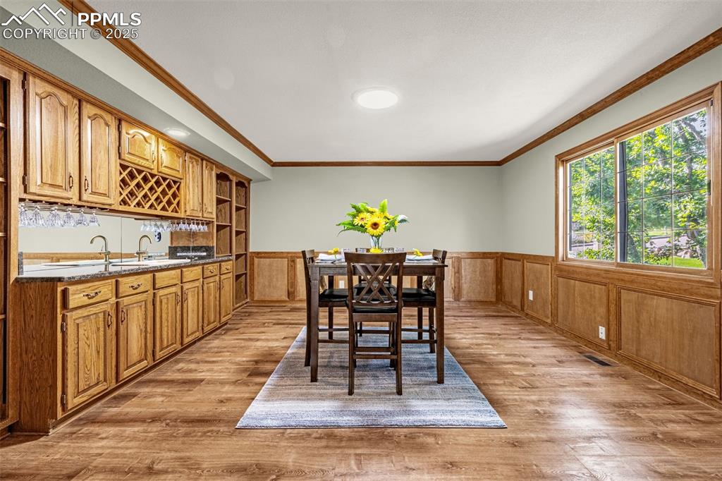 Image 8 of 26: Office/entertainment room with French doors and wetbar