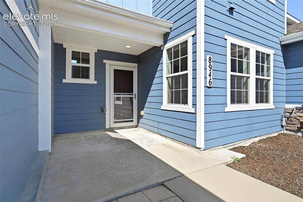 Image 10 of 45: Blue horizontal siding exterior with contrasting white trim.