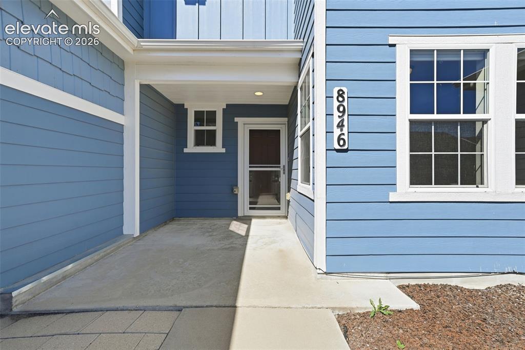 Image 11 of 45: Covered entryway with cozy patio.