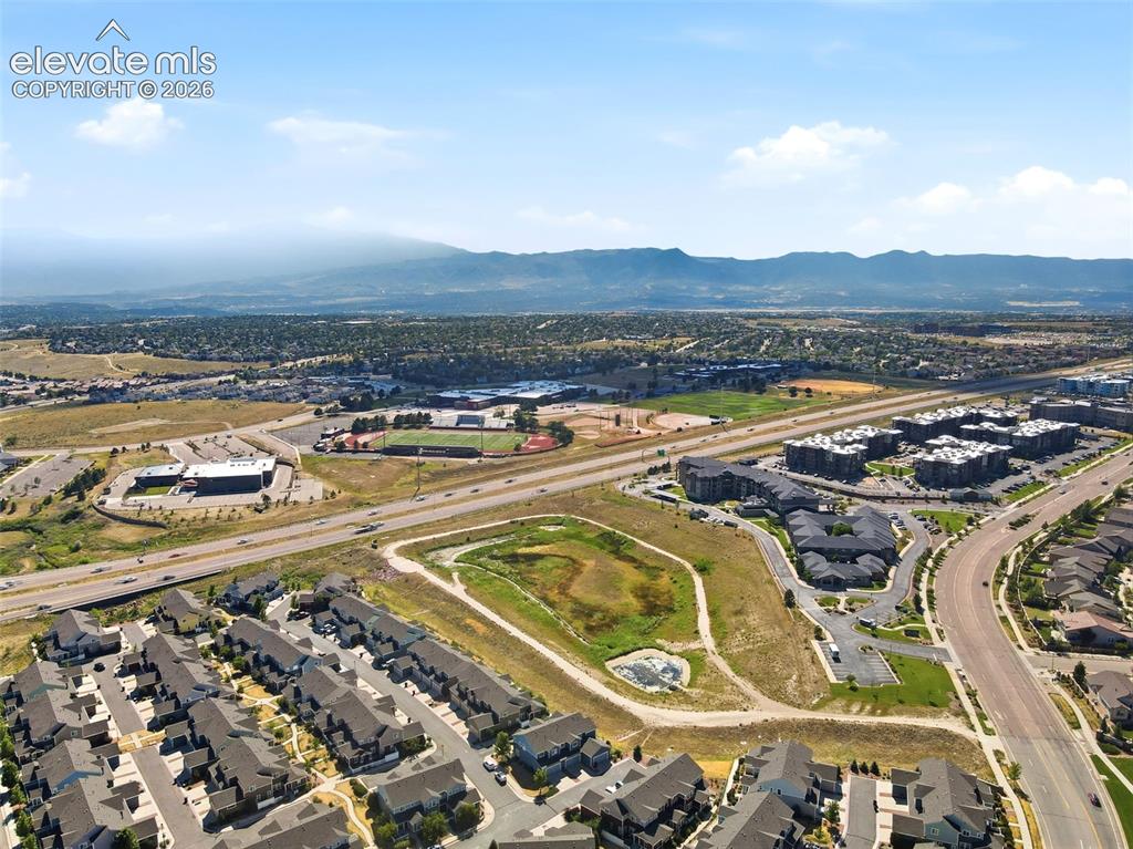 Image 12 of 45: Aerial perspective showcasing a residential area with mountain views.