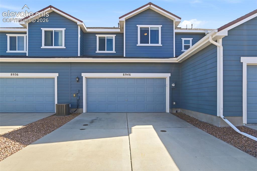 Image 16 of 45: Oversized 2-car garage with concrete driveway.