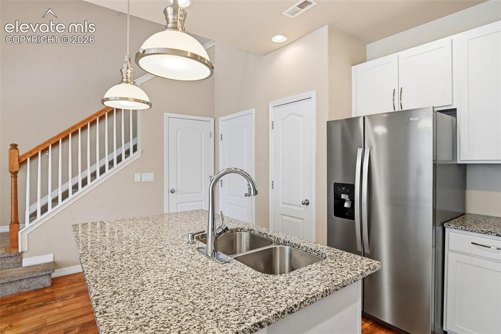 Image 18 of 45: Kitchen island featuring a dual basin stainless steel sink with a high-arc 