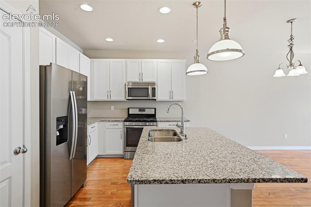 Image 21 of 45: Modern functional kitchen with granite countertops.