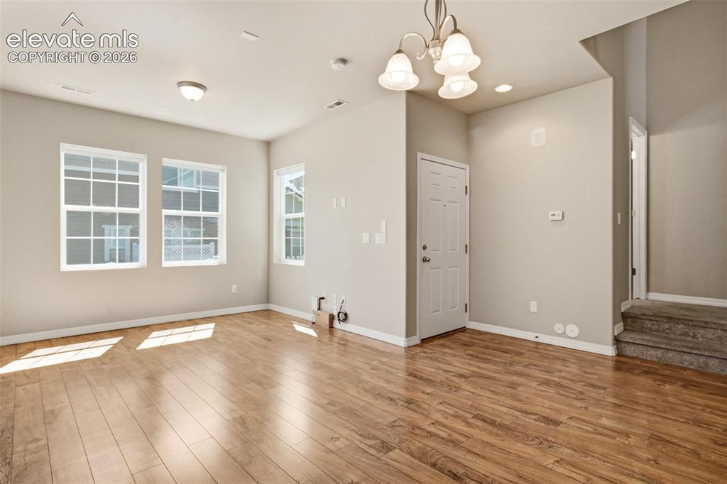 Image 28 of 45: Spacious Living with lots of natural light and Front Entry.