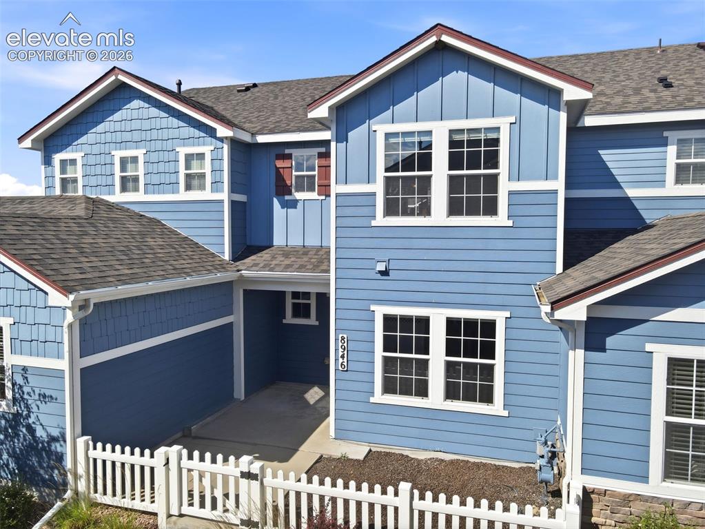 Image 3 of 45: Multi-level facade featuring blue horizontal siding, scallop shingles, whit