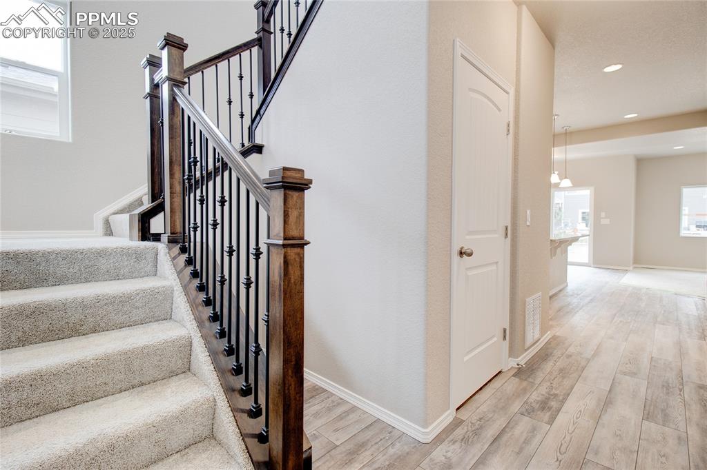 Image 2 of 24: Stairway featuring wood finished floors and recessed lighting