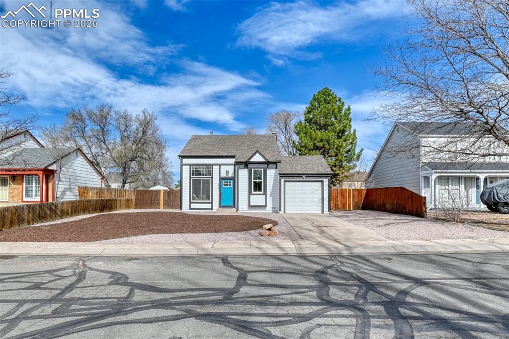 Image 2 of 44: View of front of home with driveway, a garage, and a shingled roof