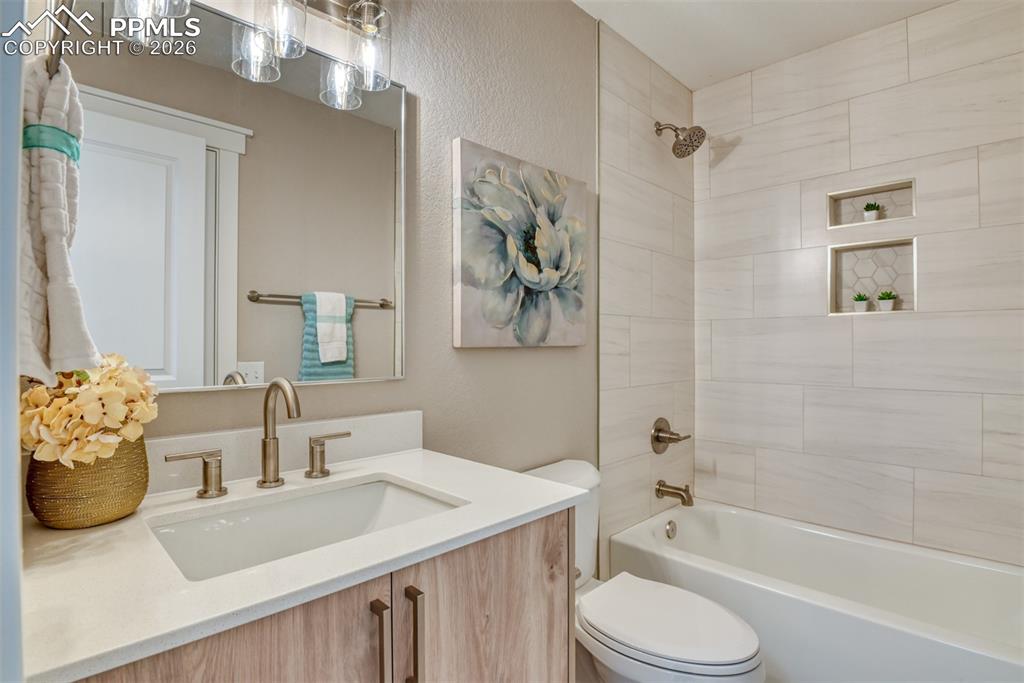 Image 23 of 44: Full bathroom featuring vanity, washtub / shower combination, and a texture
