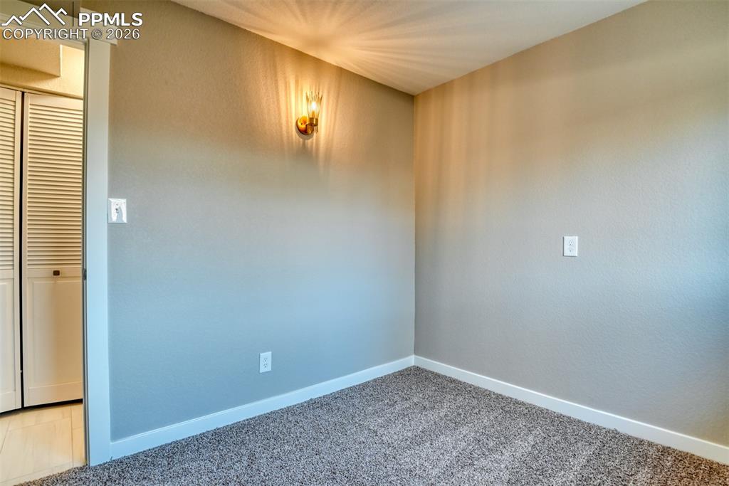 Image 34 of 44: Spare room with carpet floors and baseboards