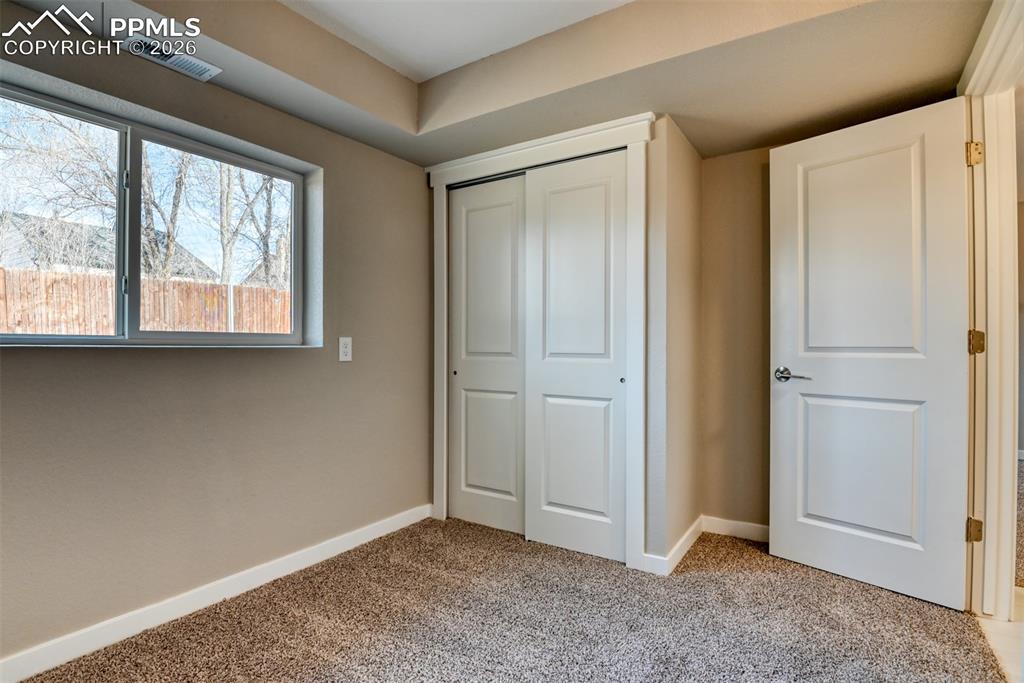 Image 36 of 44: Unfurnished bedroom with light colored carpet and a closet