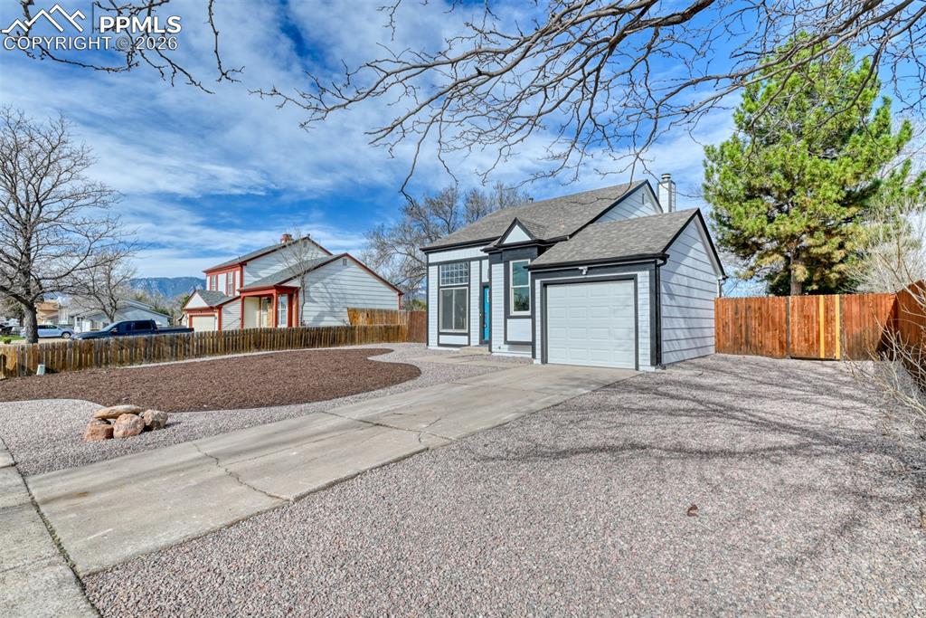 Image 4 of 44: Single story home with concrete driveway, a garage, and roof with shingles