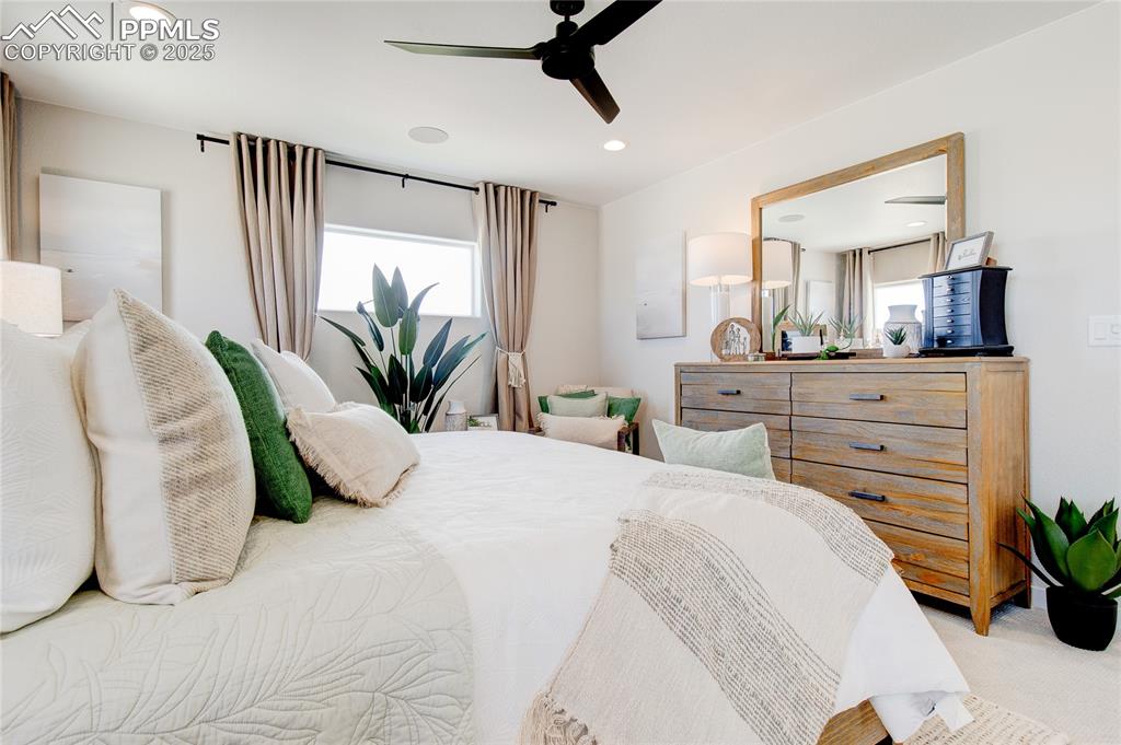 Image 10 of 32: Bedroom featuring multiple windows, ceiling fan, recessed lighting, and car