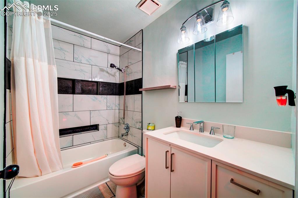 Image 11 of 36: updated full bath with custon tile work