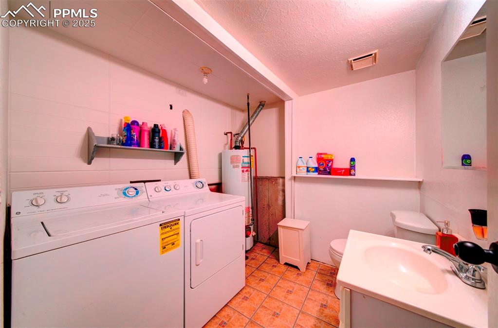 Image 18 of 36: lower level half bath laundryroom combo