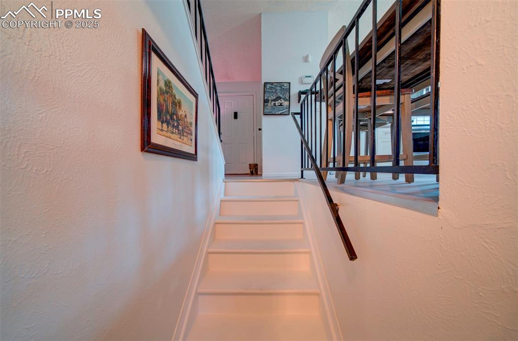 Image 24 of 36: stairs leading to main level front entry