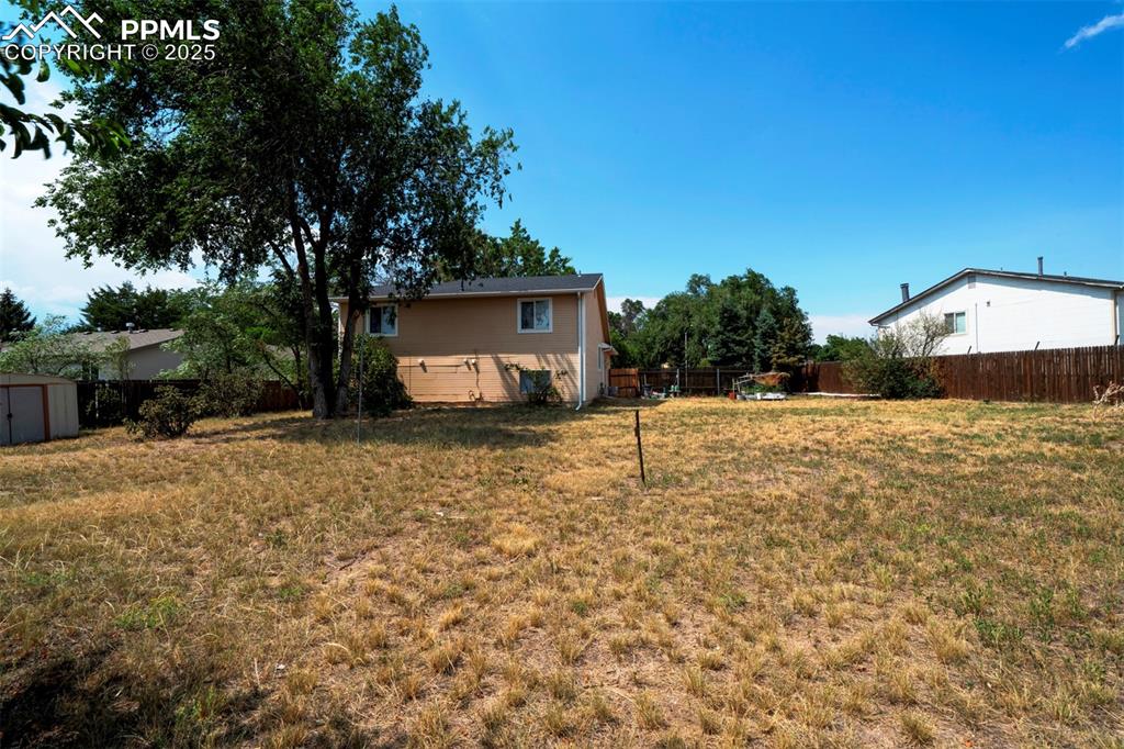 Image 27 of 36: back yard facing house.
Includes 2 sheds and mowers