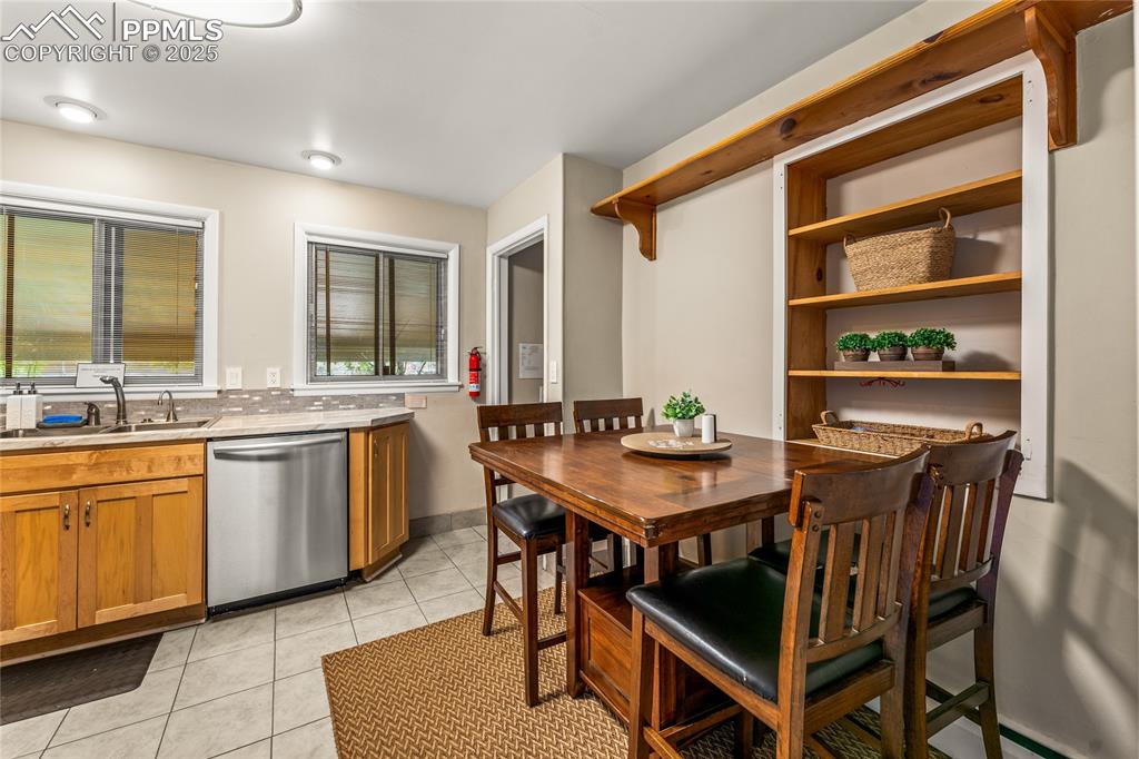 Image 11 of 42: Dining room with light tile patterned floors