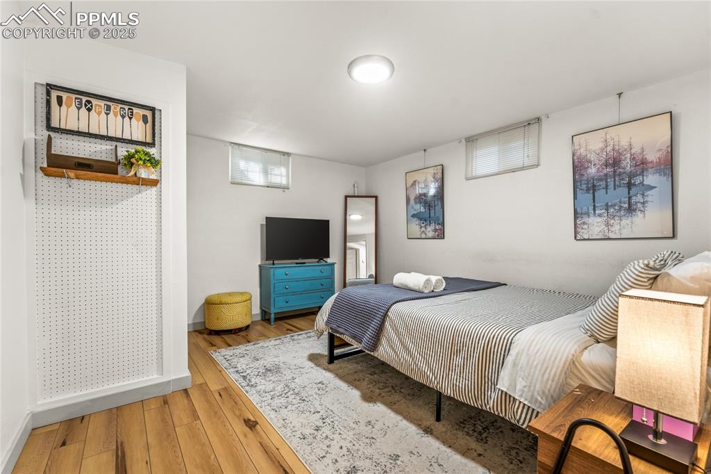 Image 23 of 42: Bedroom with hardwood / wood-style flooring and multiple windows