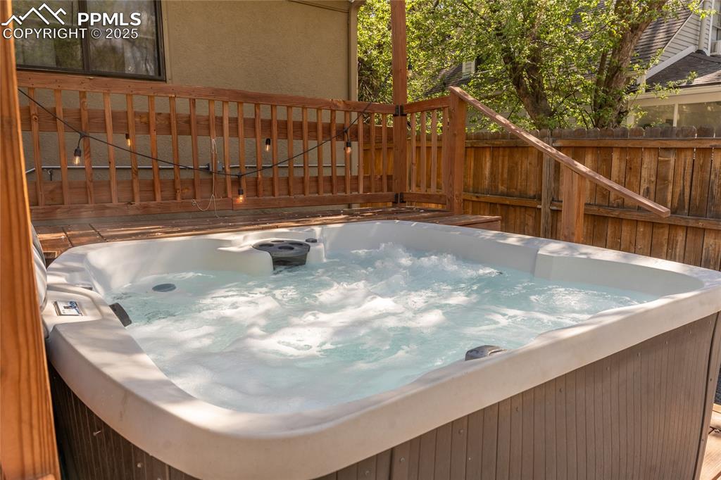 Image 40 of 42: Deck featuring a hot tub