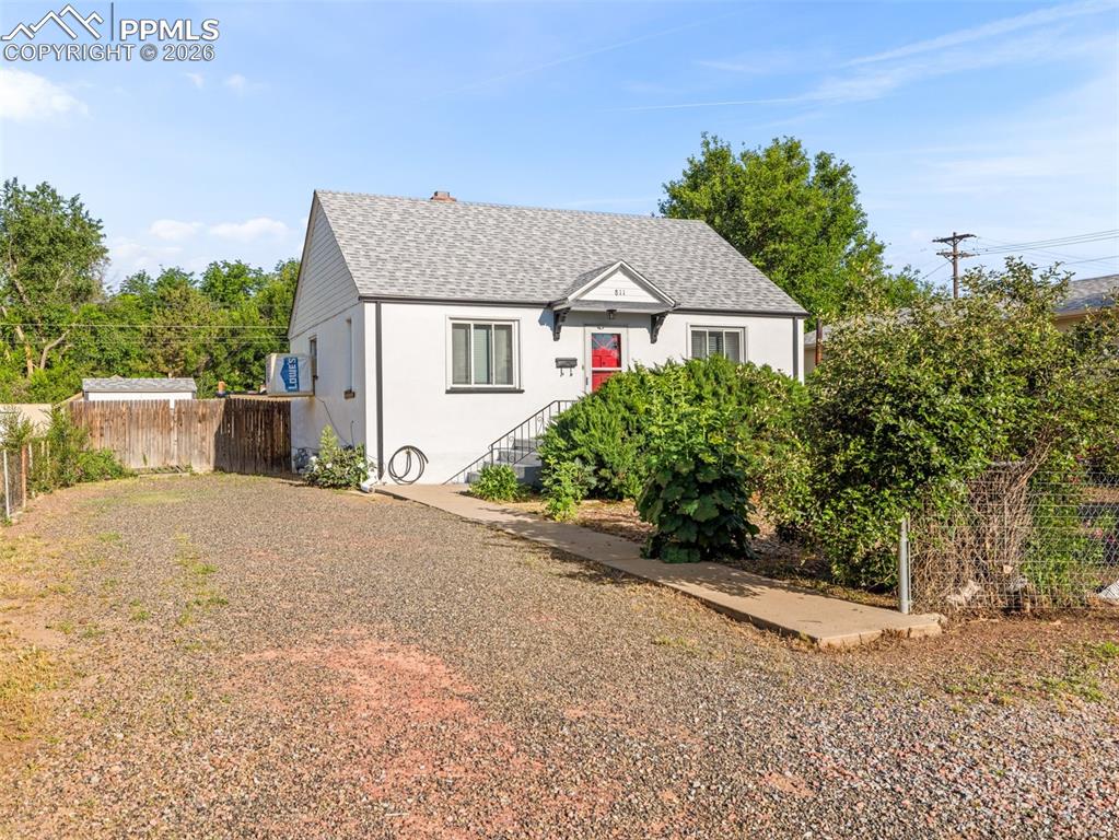 Image 2 of 10: Bungalow-style home featuring roof with shingles and stucco siding