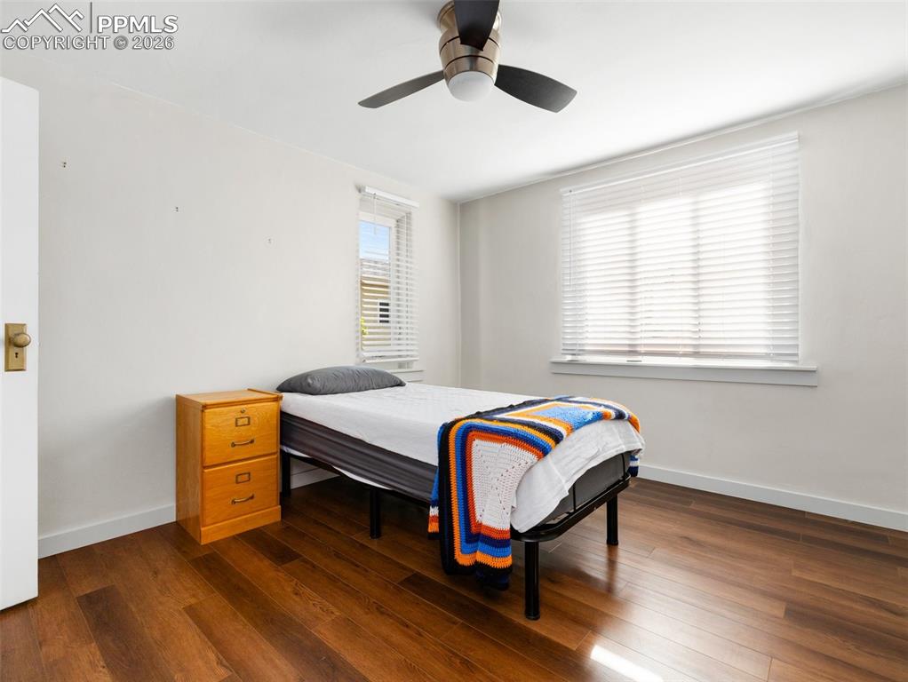 Image 6 of 10: Bedroom featuring dark wood-style flooring and a ceiling fan