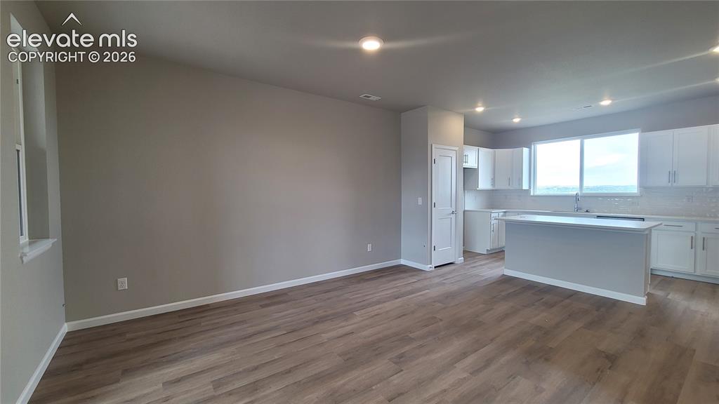 Image 12 of 32: Dining area with LVP flooring ready to host dinner parties! 